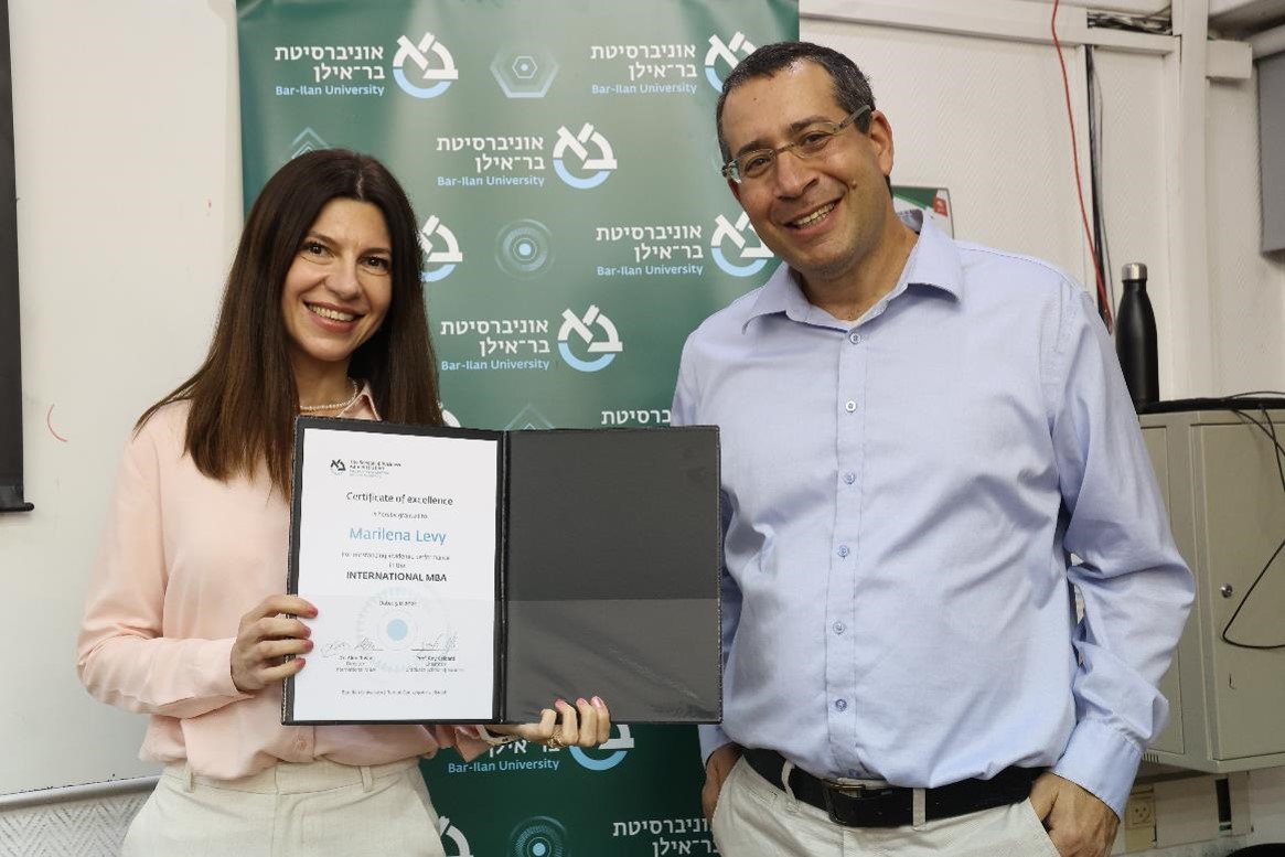 Dr. Alon Raviv presents a Certificate of Excellence to Marilena Levy